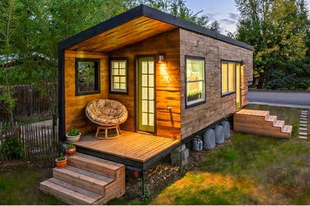 This tiny house, built by Macy Miller, cost less than $12000. She bought an old RV for $500 and used recycled materials, money saving features such as a composting toilet, and radiant floor heating to save money on building.