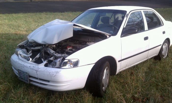 This car went through a hedge and was probably declared a total loss. Used parts and no paint would get this back on the road cheap and ugly--with the rest of the insurance money in hand.