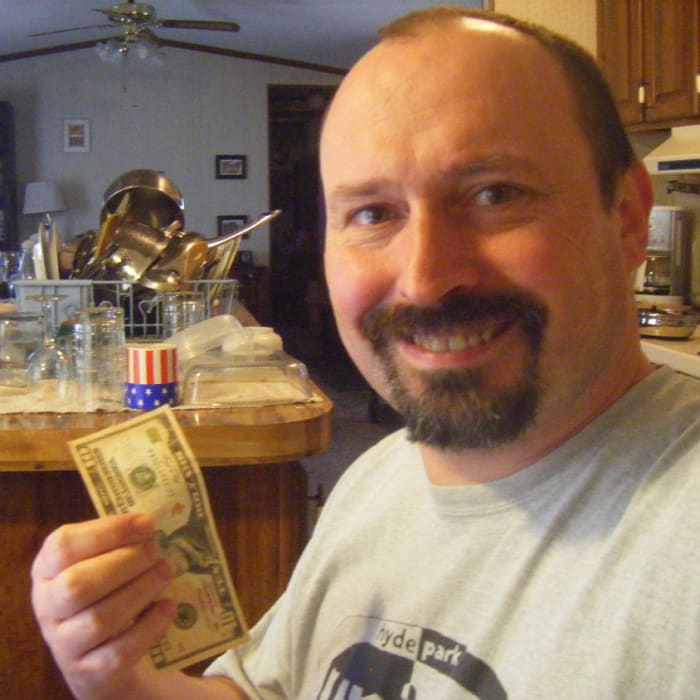The author with a dollar bill. It is easy to earn with Mechanical Turk, but it is difficult to earn a living wage. Over time, the payment levels have gradually shrunk.