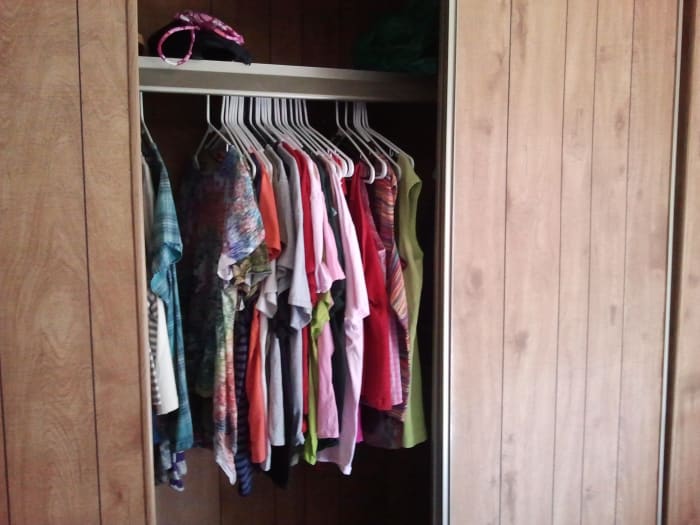 My house may be short on aesthetics, but it's long on storage space. I have a total of 20 kitchen cabinets and four of these huge closets—you're only seeing one side of it open here.