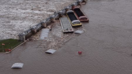 Cover tops made of steel or fiberglass are used to protect certain kinds of cargo like that of grain barges.