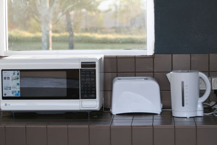 If you camp on an unpowered site in a caravan park, you'll have access to their cooking facilities. Some offer indoor and outdoor cooking options and even let you use a fridge. Choose a nice clean resort and negotiate a weekly or monthly rate.