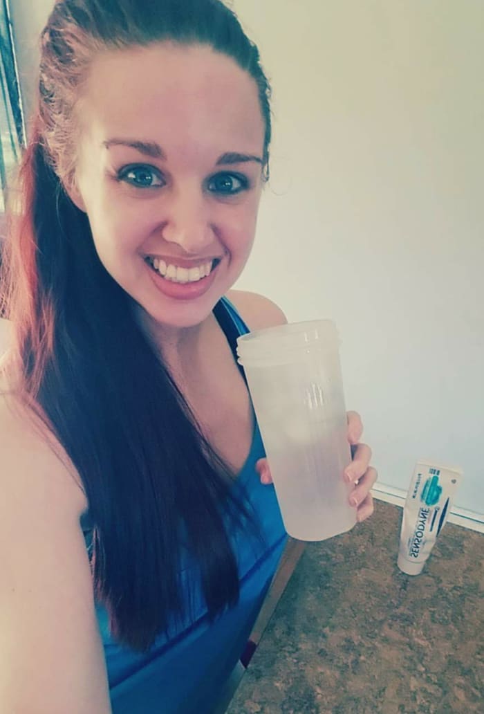 Enjoying a glass of ice water after a workout pain-free, thanks to my free tube of Sensodyne toothpaste.
