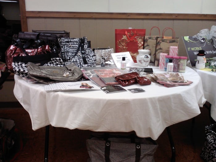 Dalaina's display includes both purse and candle products. She is introducing new products to the market with a paddle party!