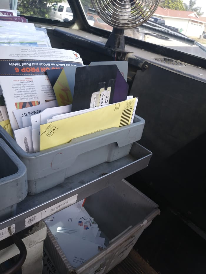 Mel uses a stupidly simple system of MSP breaker cards to keep the "mystery mail" separated from the outgoing. Note the outgoing stamped mail is in the bucket on the floor.