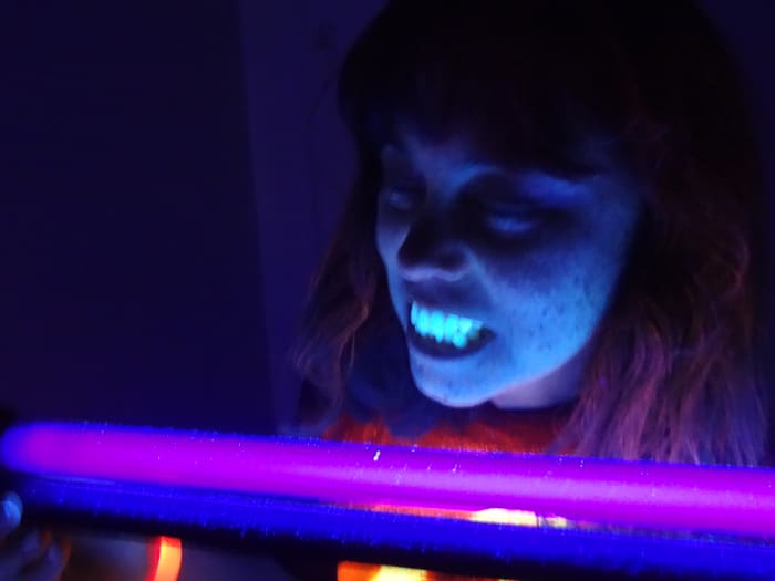 Fluorescent hair spray creates the pink tint in my hair. (Teeth and freckles definitely show up under a black light.)