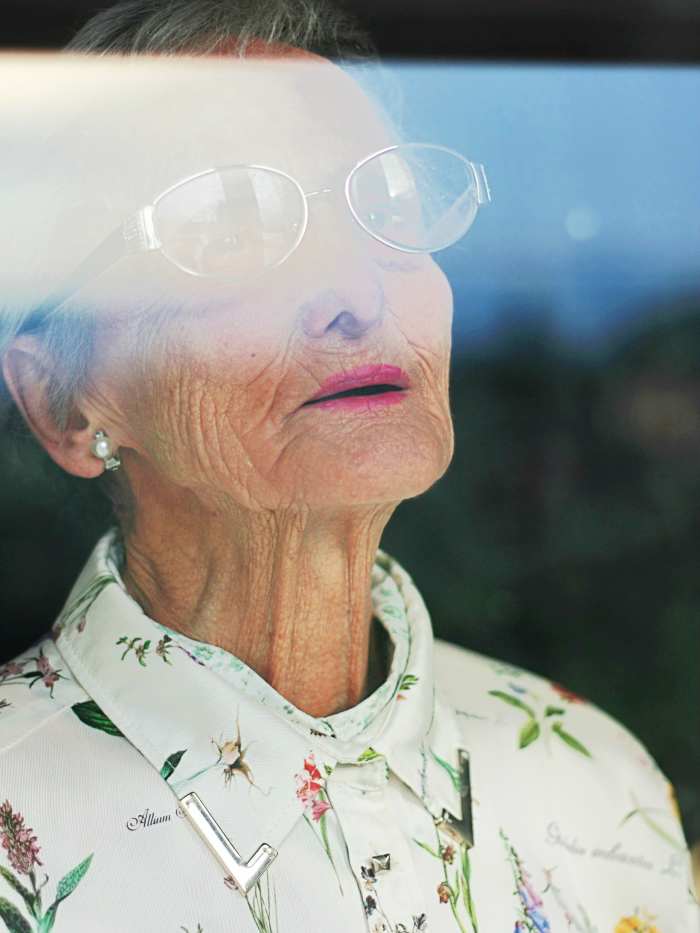 This lady is not my former neighbor Edna, but you get the idea. Edna must have watched that bird feeder and orange cat many times from her window.
