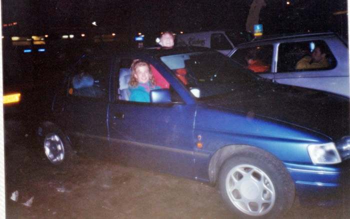 My friend Andrea from Blackpool sitting in the driving seat of the hired Rover, with Julia putting her head out of the sunroof, on the services, 1991. (No, she didn't travel on the motorway standing up like that!)