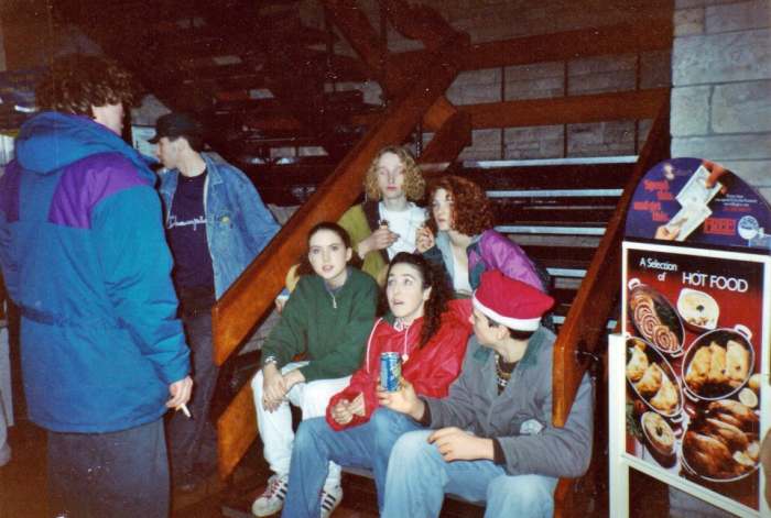 Motorway services after Monroes (1990). My friend Kat is sitting at the back, on the right. Cushla is at the front on the left and next to her, Nyree, in the red jacket.