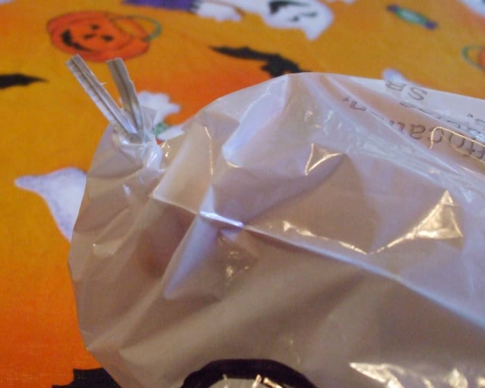 Twist ties emerge: ready to be connected to a longer string positioning your ghost decoration in the perfect outside spot.