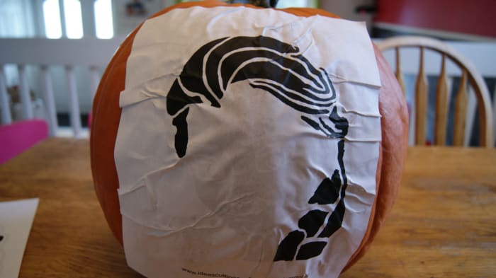 The spray adhesive turns your template into a giant sticker. You can lift the stencil as many times as you want. Try not to get too many wrinkles.