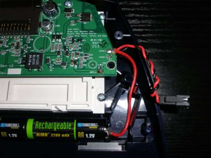 The new red wire I had soldered to the NiMH(+) solder pad I then soldered to the positive terminal of the battery tray, in place of the old red wire. Note I left the original battery connector as is.