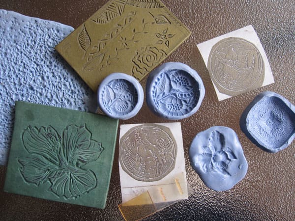 Flexible texture sheets and molds made silicone molding compound; carved cured polymer clay textures; tear-away texture papers; and small photopolymer plates.
