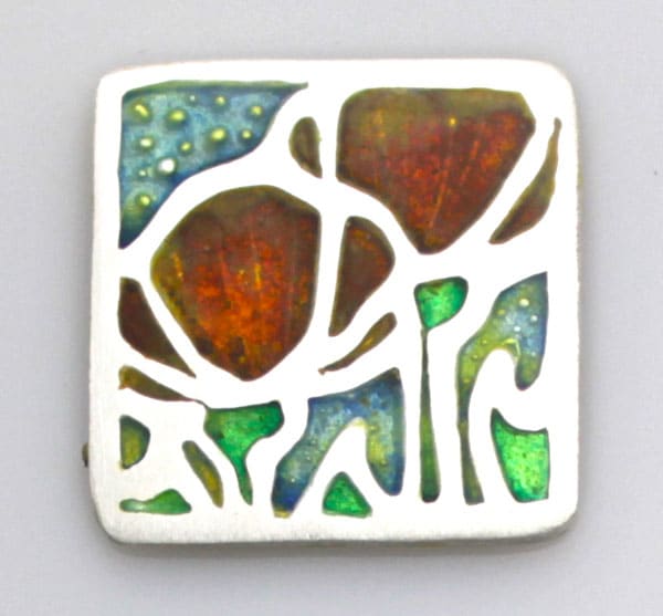 Silver metal clay impressed with a deep-relief texture created with a Silhouette CAMEO on Scratch-Foam, then fired and filled with enamel.