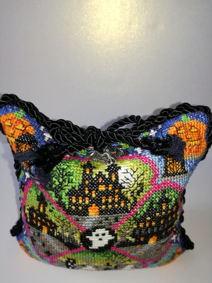7. My fully finished object is a piece of Halloween cross stitch I made into a cushion and trimmed with black cord & a silver bat charm.