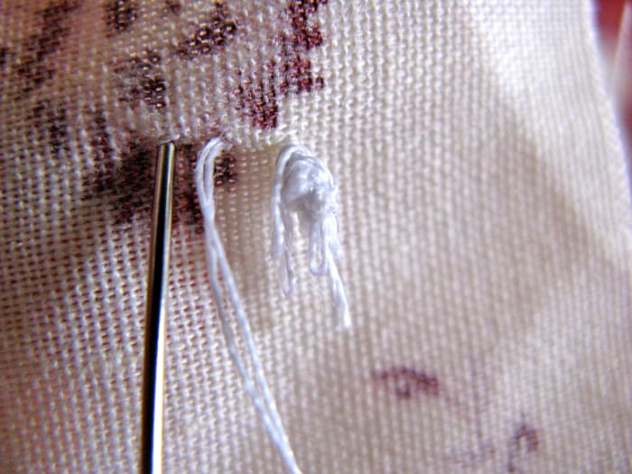 Continue making your stitches evenly, entering the fabric on the same side your thread is coming out of.
