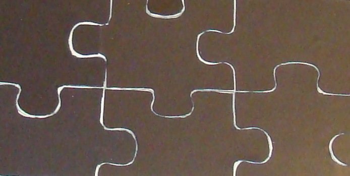 Trimming at an angle reveals a bit of the wood, and ensures that the magnetic backing will not interfere with putting the puzzle together.