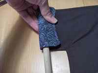 Make sure the fabric fits around the dowel. Then, pin the fabric at the right spot and slide the handle back out.