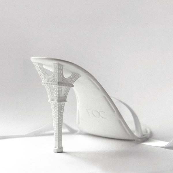 3D printed stiletto features intricate Eiffel Tower heel detail.