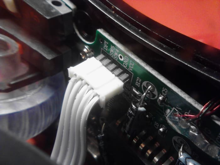 This small ribbon cable must be carefully removed before top and bottom halves can be separated. Your mouse may vary, check the insides before separating any parts from one another. Damaging any of these connected cables would not be good.