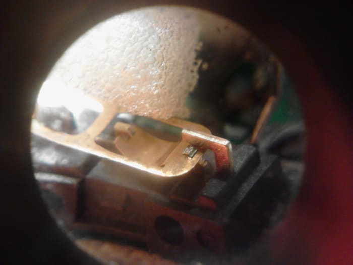 Magnified shot of the switch with the small piece of memory foam just above it waiting to be inserted into the switch.
