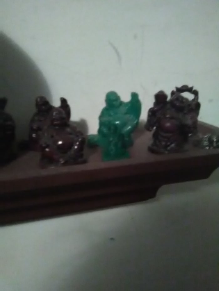 3D printed model is the small green plastic statue in front of the jade (green) laughing Buddha. In Cura, 3D objects can be scaled for different sizes and slightly different shapes.