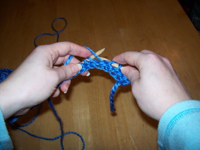 Insert right needle into first stitch on left needle. The right needle will be in front of the left needle.