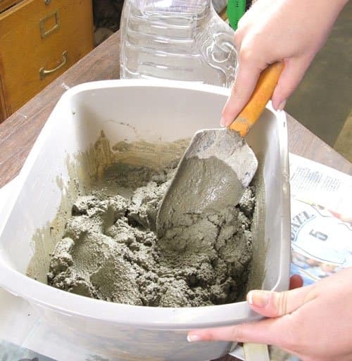 Step 5. Using a trowel, thoroughly mix the dry mortar with the water until it is like peanut butter. If the mix is too dry add a small amount of water until it is of the desired consistency. If is too runny add dry mortar.
