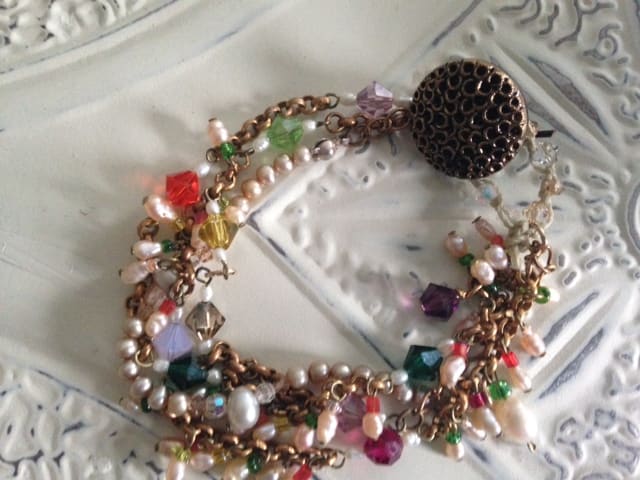 Sundance-inspired Gypsy button bracelet made with freshwater pearls, crystals, seed beads, leather, gold chain and a vintage button clasp.