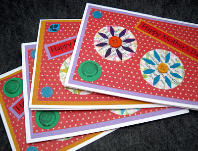 I used a flower punch with text and solid color magazine pages, which I layered over scrapbook paper punched circles.