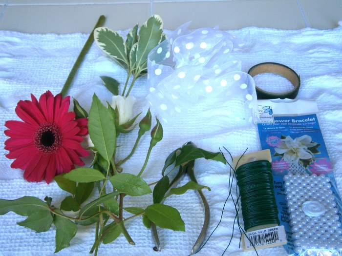 From left to right: flowers of choice, ribbon, wire cutter, floral wire, floral tape and flower bracelet.