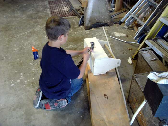 Nailing the toolbox together. Small finish nails were not easy for a novice and there were some goofs, but the job got done.