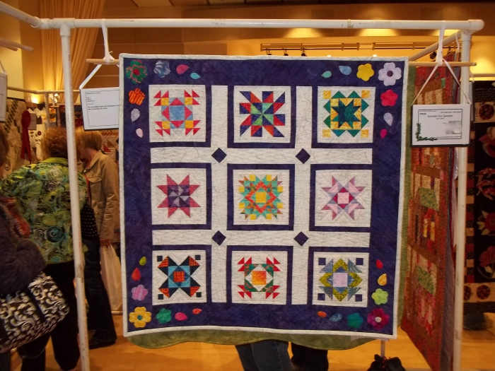 "Summer Fun Sampler," my original layout using traditional blocks. Here it is hanging in a juried show.