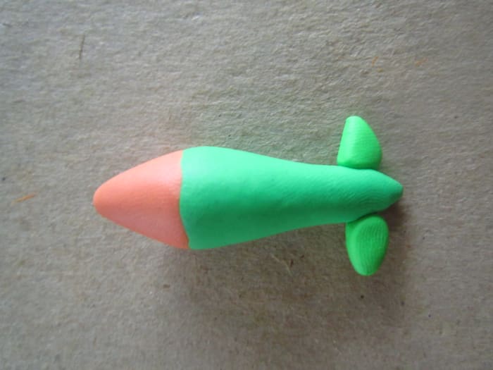 Next I took a ball of the clay for the body flattened it on one side and pressed it on to the tail--blending the edges and creating a cone shape.
