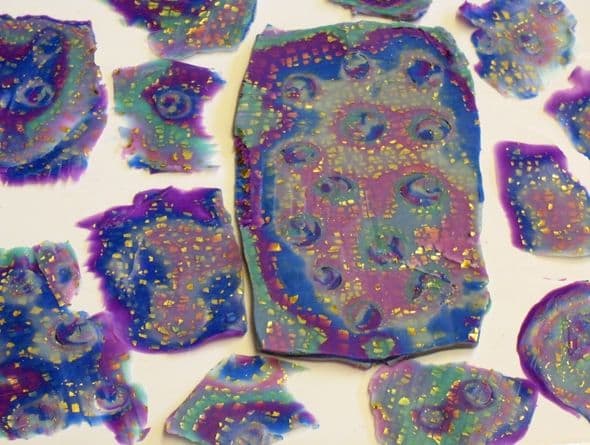 Shaved polymer clay mokume gane stack. Each slice has fewer colors spaced more widely apart because the layers in the mokume stack were too thick.