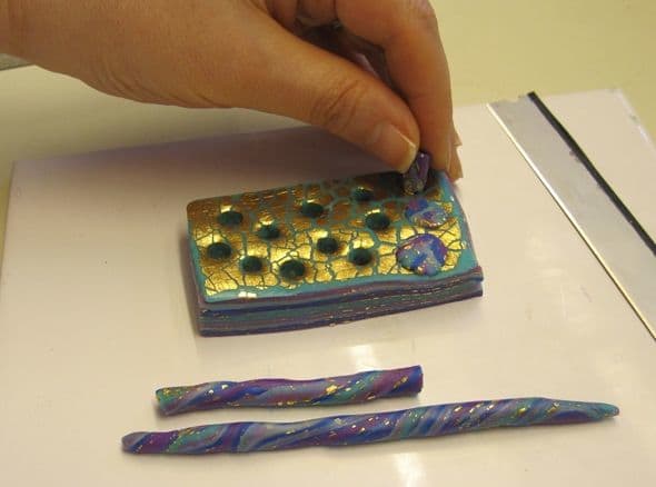 Plugging holes in a polymer clay mokume stack with snakes make from the optional trimmings from Step 3