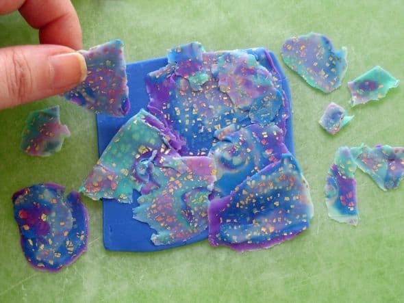 Playing around with the arrangement of shaved slices of polymer clay mokume gane that will be rolled onto the backing sheet individually to create a patterned veneer