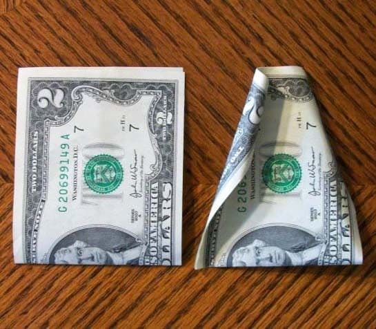 Step #1: Fold the bills in half first as it will make curling the edges easier.