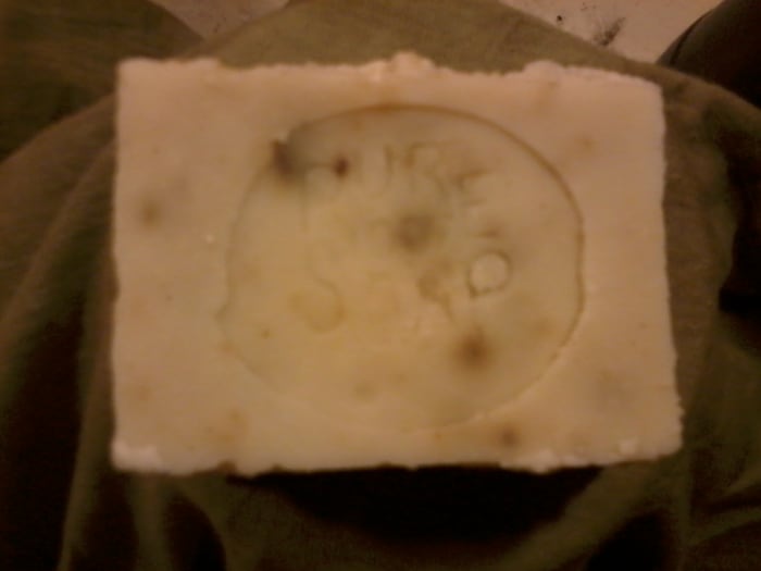 My standard soap recipe usually produces a white bar. This time I colored it gently with lemon balm.