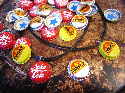 Create simple button cap necklaces with genuine metal caps by punching a hole in the top, attaching a jump ring, and stringing a cord or chain through it.
