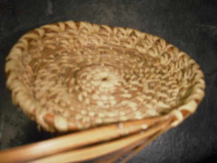Once the base of the pine needle basket is the right size, start to turn the coil up to form the basket sides.