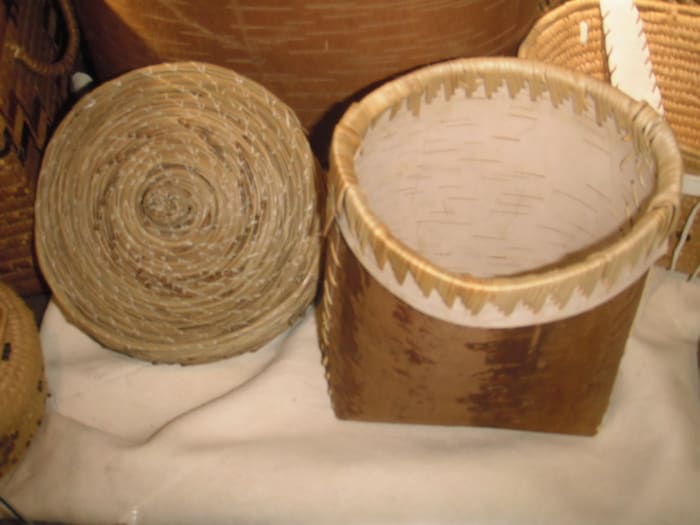 Interior Salish pine needle basket, left, and birch bark basket, right. Birch bark for baskets is harvested in the spring once the sap is up in the tree. The bark-harvesting season lasts approximately ten days, so the tree has time to heal.