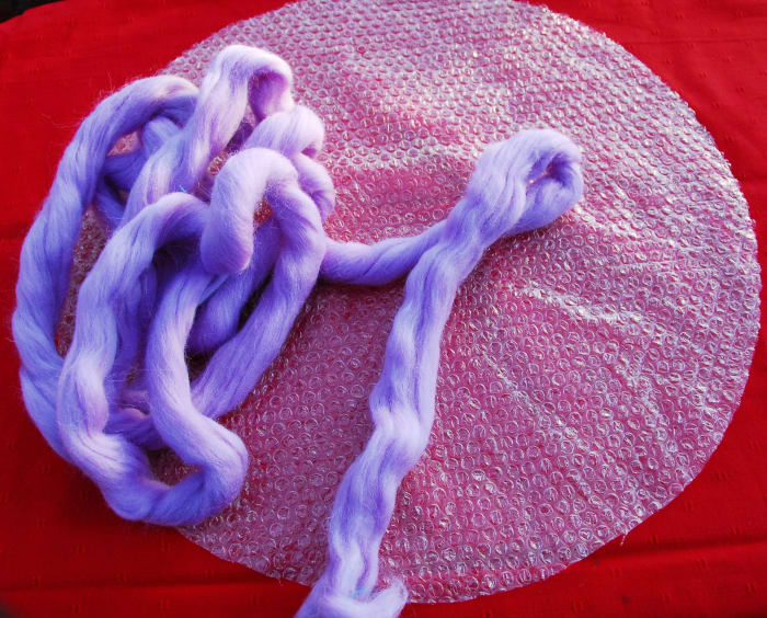 Your wool roving or tops will look similar to this. Buy roving or tops which is specifically meant to be used for felting.