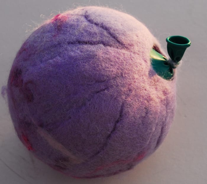 At this stage I usually untie the balloon, remove a little air, knot it again and put it back in the tumble dryer for another ten minutes or so - this helps shrink the pod - which in turn thickens the fabric a little more.