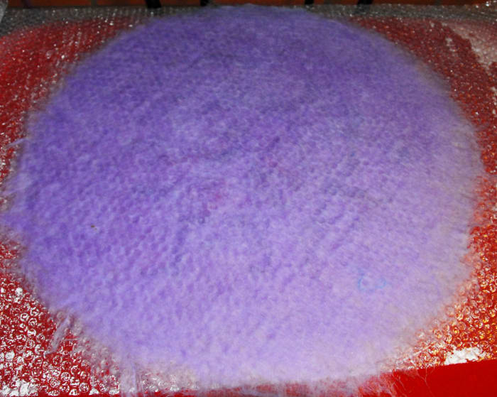 Flip the project over between two pieces of bubble wrap. It makes it easier to keep the decoration on the outside of the balloon.