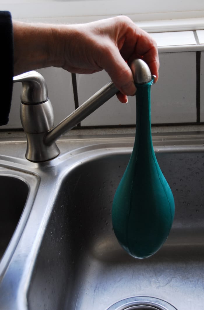 Add a little water from the kitchen tap, about quarter full. Blow it up as normal.