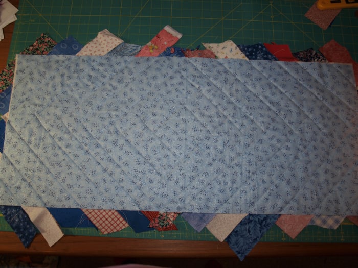 Flip the runner over and get ready to trim to size. Note the quilting design on the back of the table runner.