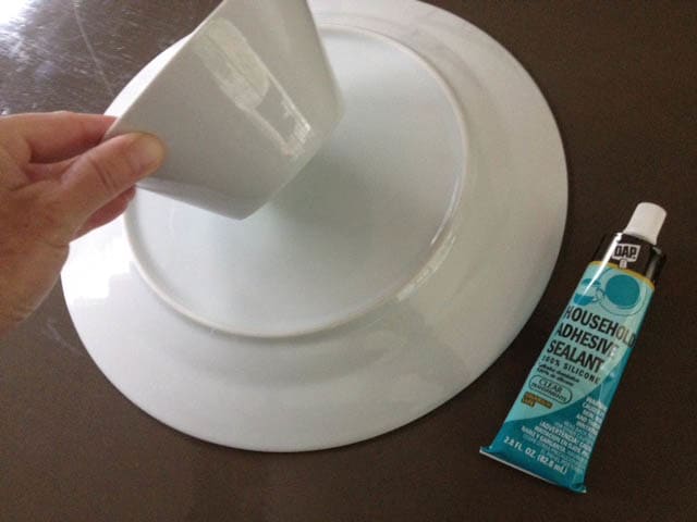 I use a marine glue when I make cake stands. It takes a few minutes to set up, but it holds nicely.