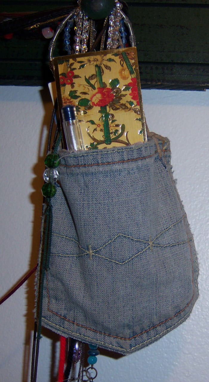 This is just the pocket from an old pair of my jeans. I punched holes in the corners and tied a length of suede through them.