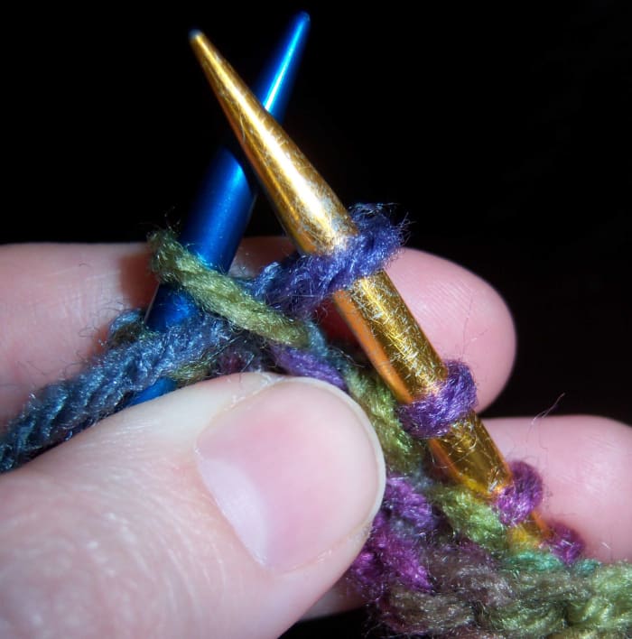 If you were going to only purl this stitch, you would let the green stitch slip from the blue needle.